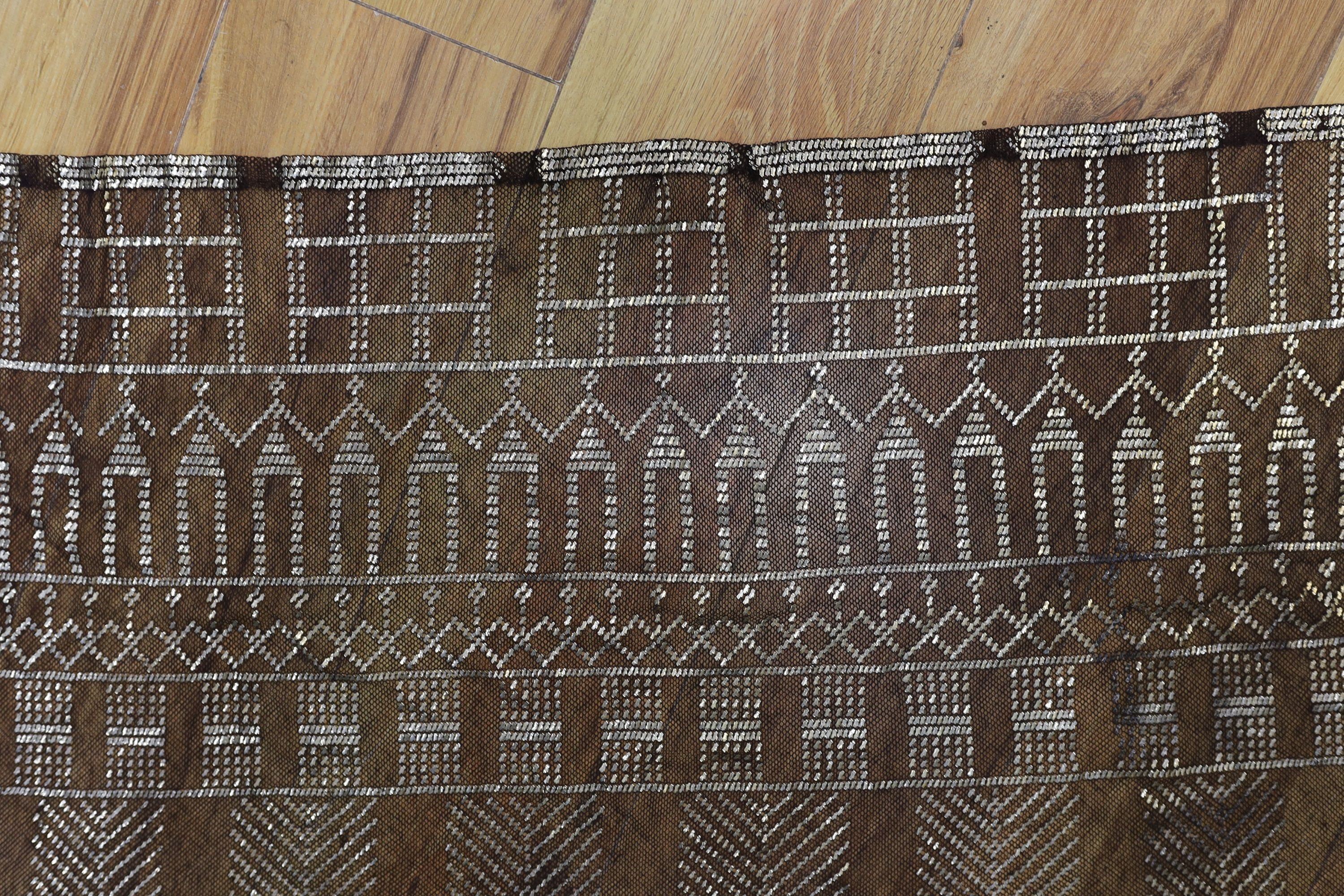 A dress made from a metal and black net Egyptian shawl; a similar shawl and a piece of shawl
